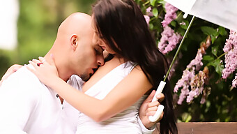 A Young Couple Indulges In Outdoor Pleasure On A Park Bench