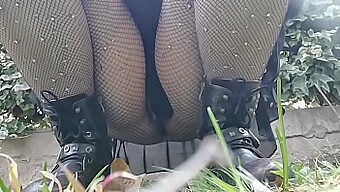 A woman pees in a public park and exposes herself to the camera in fishnet stockings