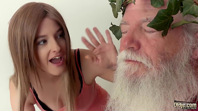 Young girl engages in sexual activity with an older man featuring a white beard